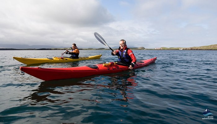 couple kayaking in arctic sea