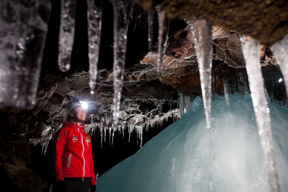 woman exploring Lofthellir Ice Cave