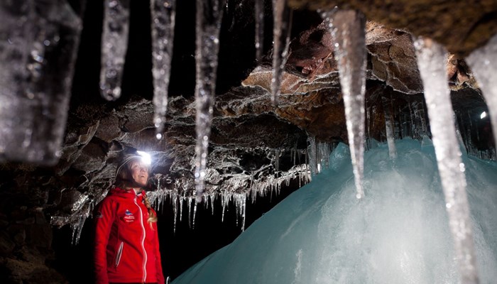 woman exploring Lofthellir Ice Cave in Iceland