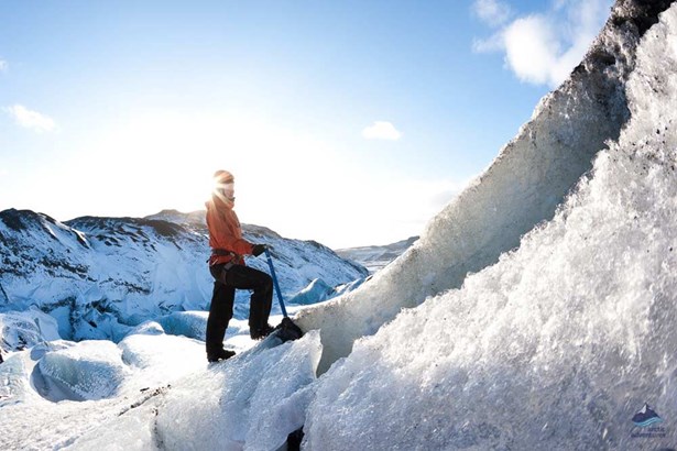woman climbing on glacier ice