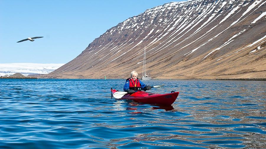 woman kayaking in Icelandic fjord