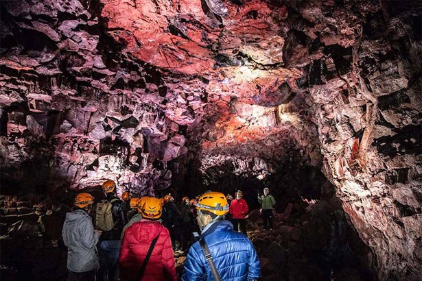 tourists inside Raufarhólshellir lava tunnel