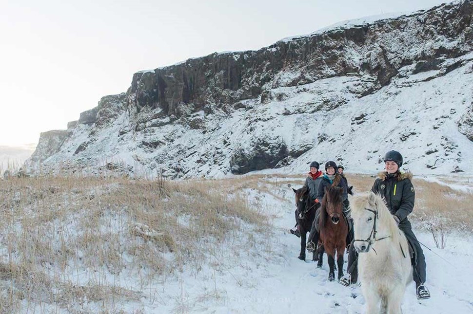 women riding Icelandic horses in winter