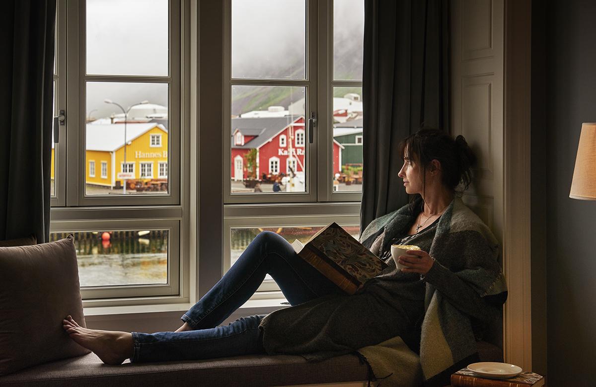 woman sitting near window