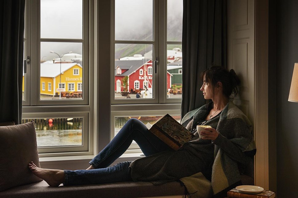 woman sitting near window