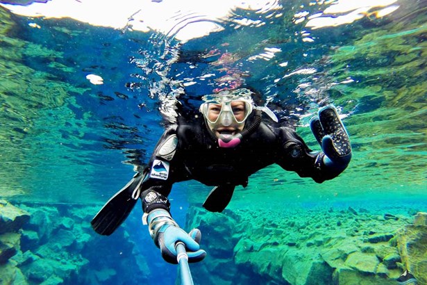 woman snorkeling at Silfra Fissure in Iceland