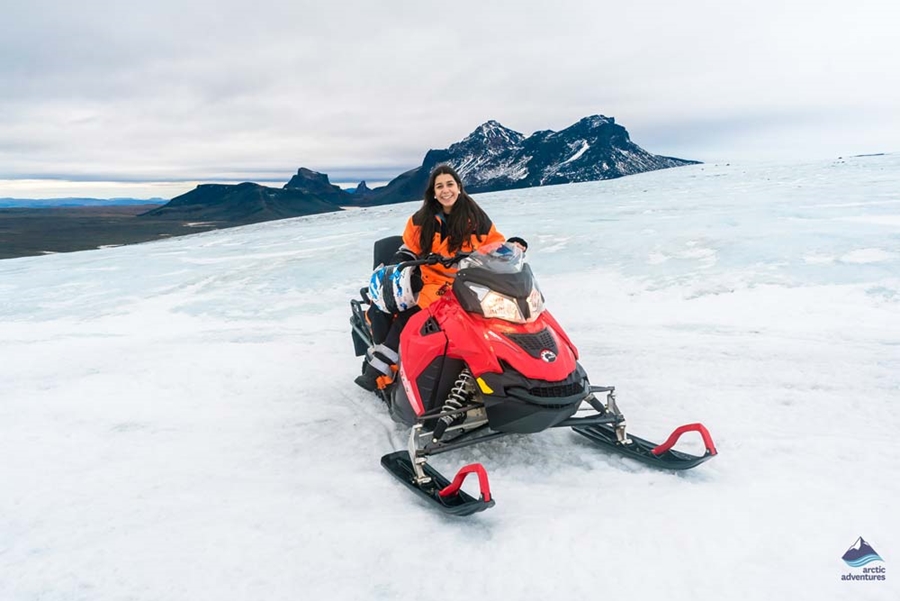 Woman sitting on a snowmobile