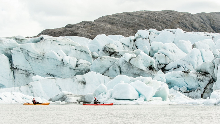 group kayaking by the glacier
