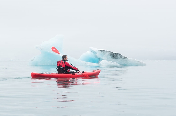 man kayaking in Icelandic glacier lagoon