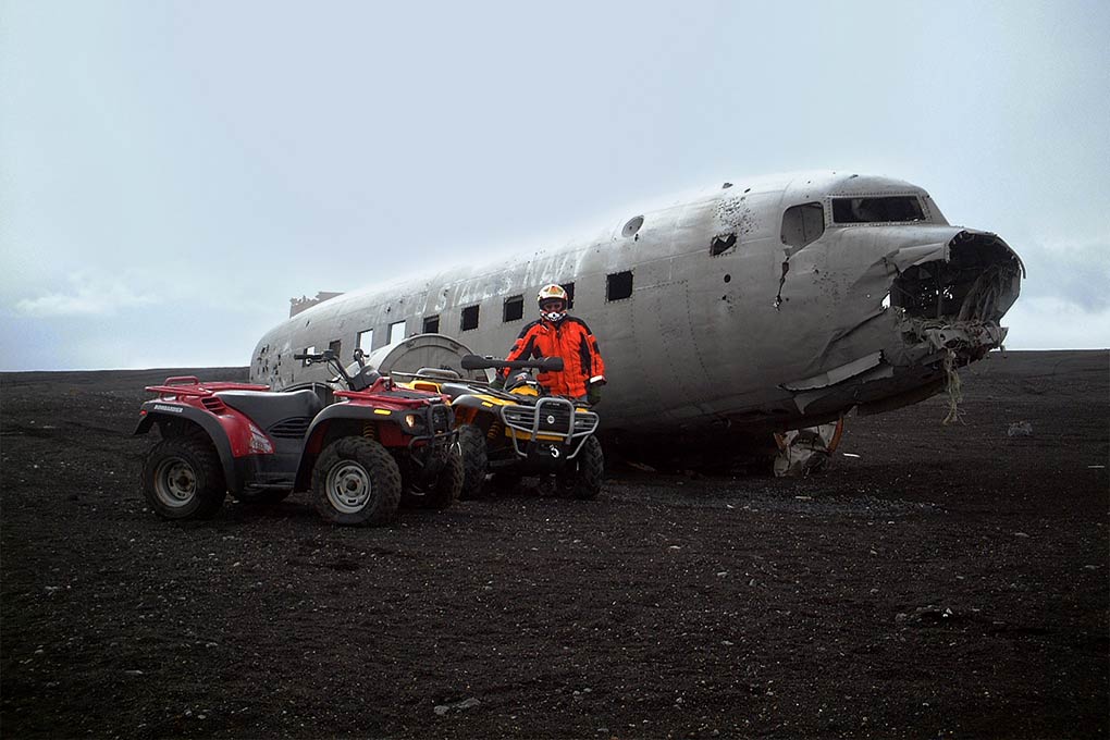 man posing with buggies at plane wreck