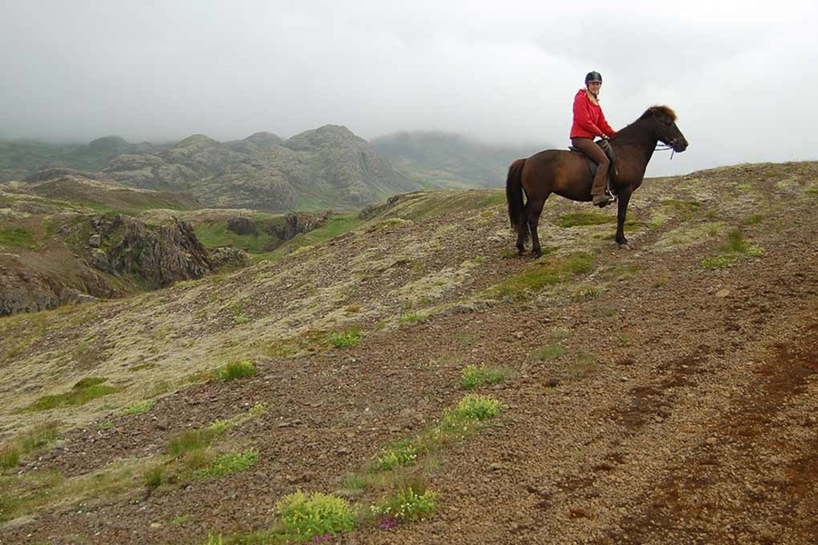 woman on horse in mountains