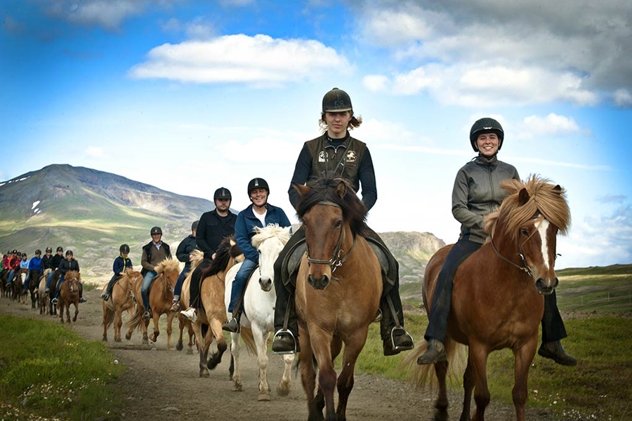 group of people riding horses