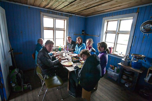 explorers having dinner in blue hut