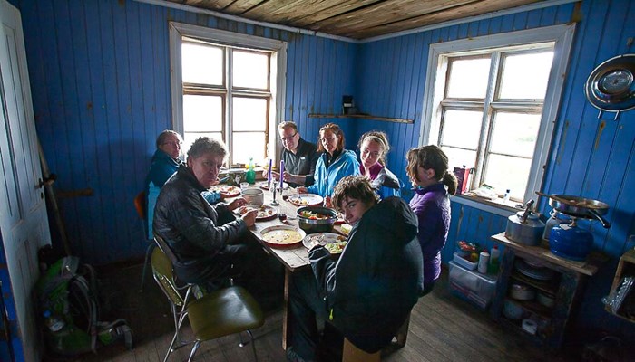 explorers having dinner in blue hut