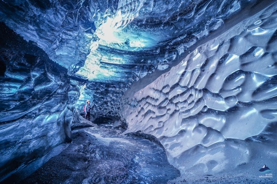 Person standing inside a glacial cave in Iceland
