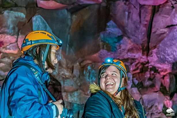 women laughing inside of Raufarholshellir lava tube