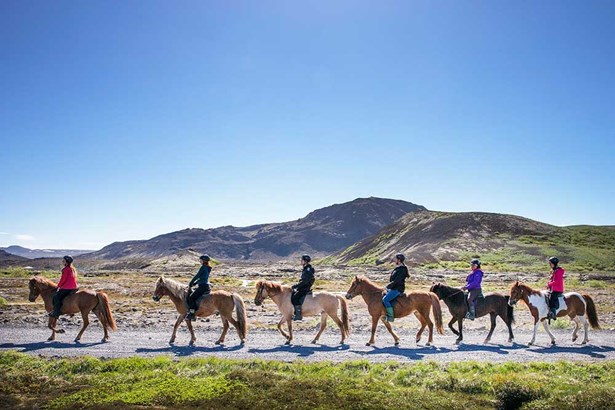 group of people horseback riding in Iceland