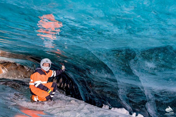 Woman exploring ice cave in Iceland