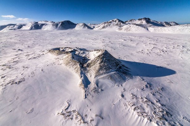 helicopter view of snowy mountain range