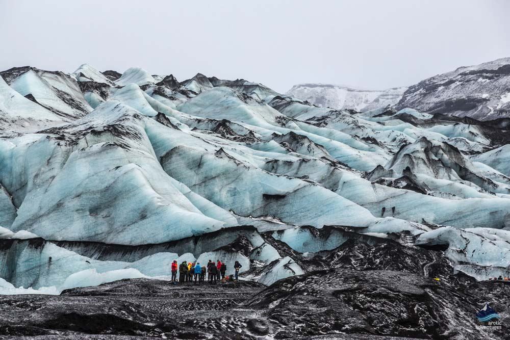 explorers by marble glacier ice