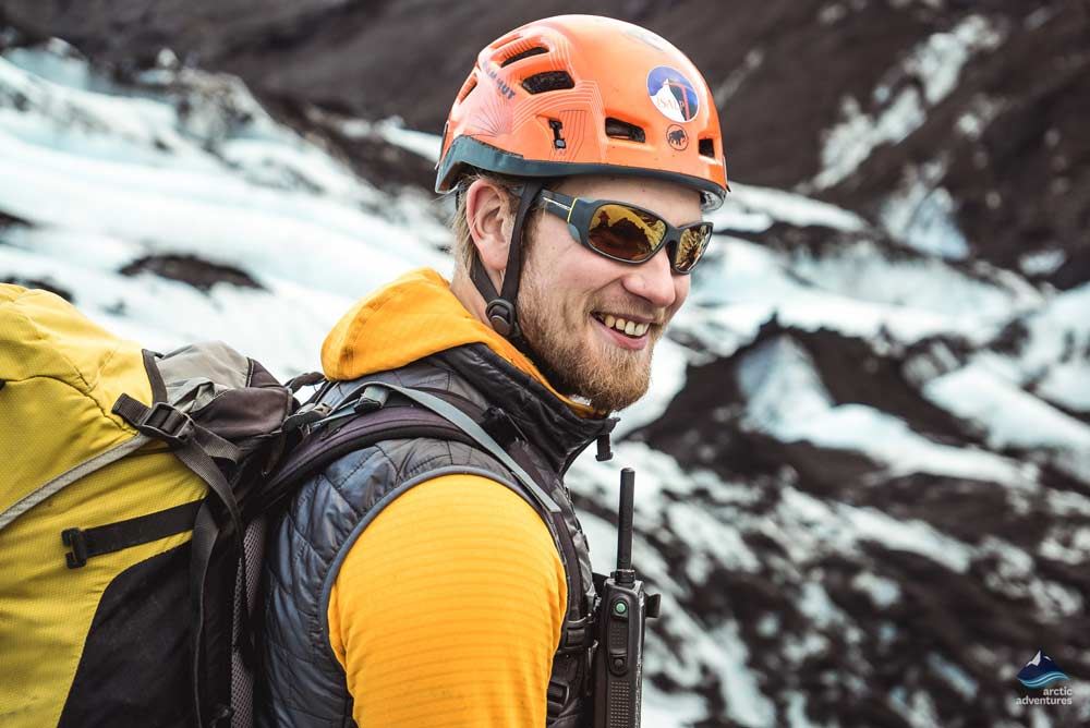 happy man hiking on a glacier