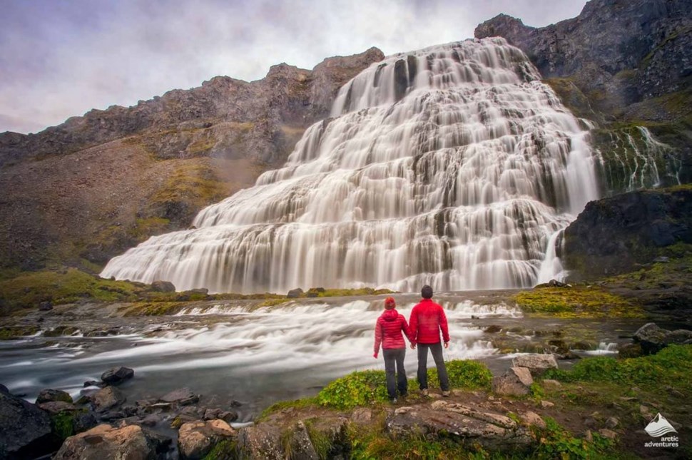 A couple standing in front of Dynjandi Waterfall Iceland