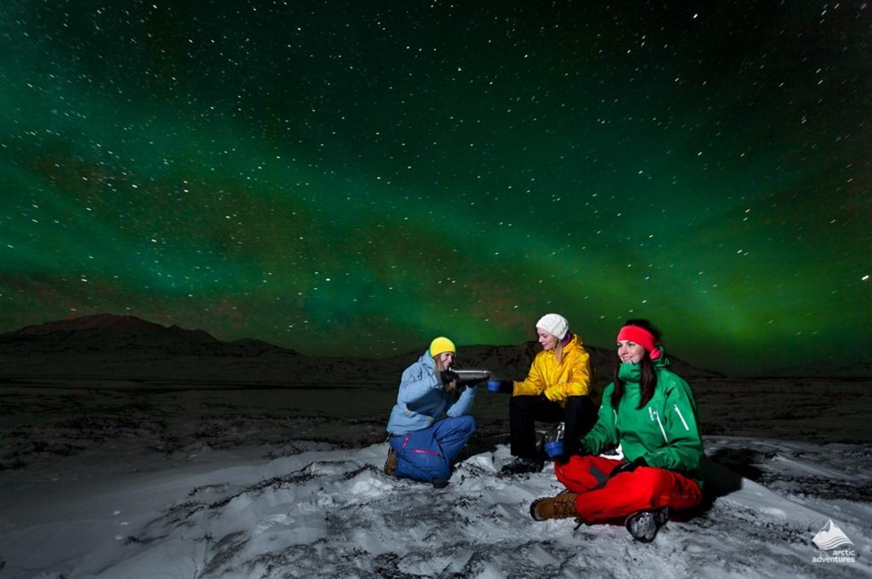 People admiring Northern Lights in Iceland
