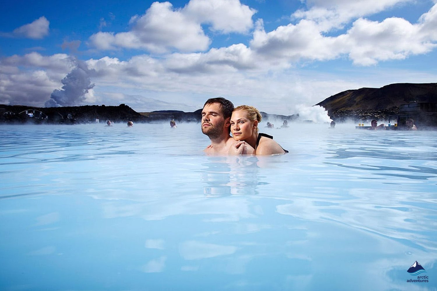 couple bathing in blue lagoon of iceland