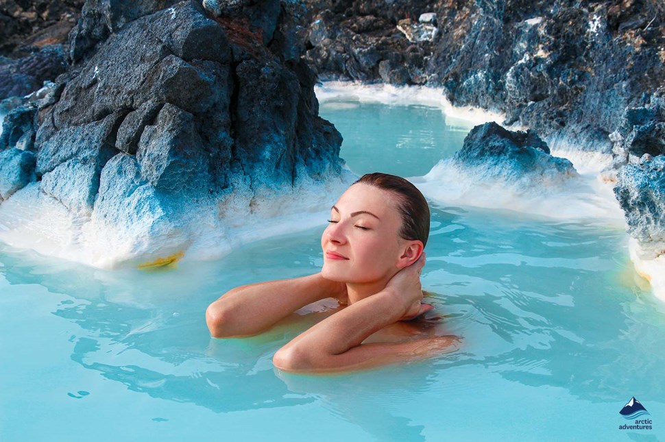 woman enjoys the blue lagoon in iceland
