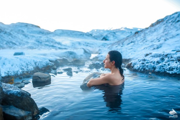 woman enjoys nature hot bath in Iceland