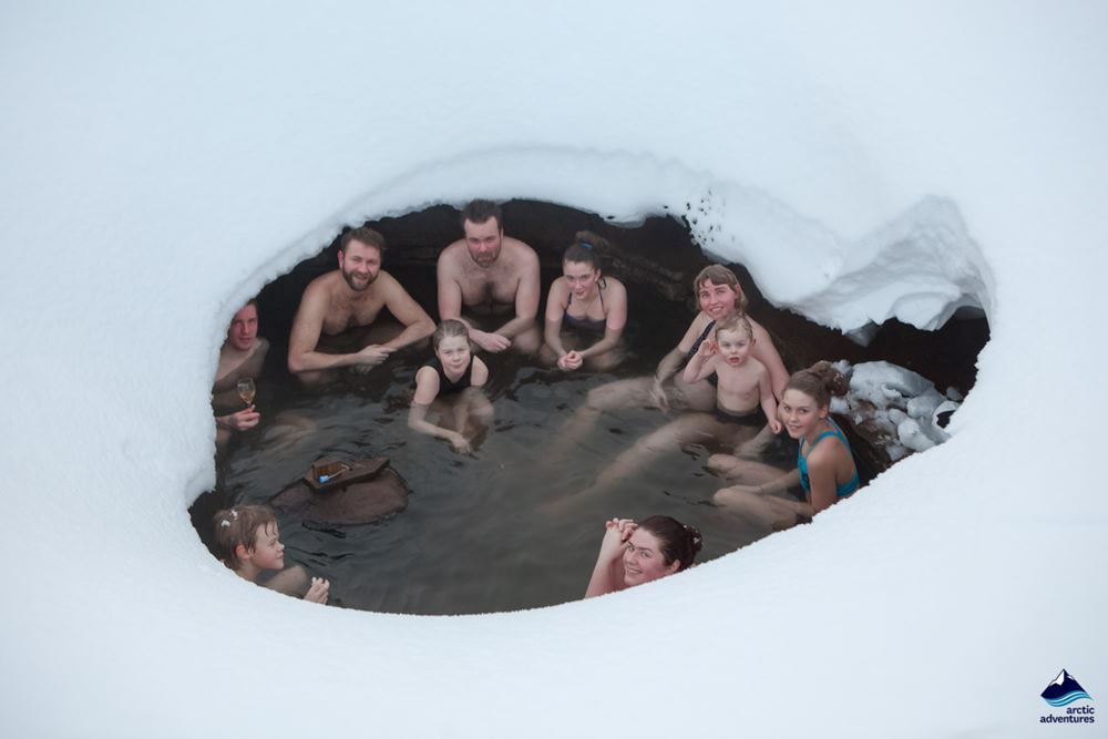 people bathe in hot spring during winter