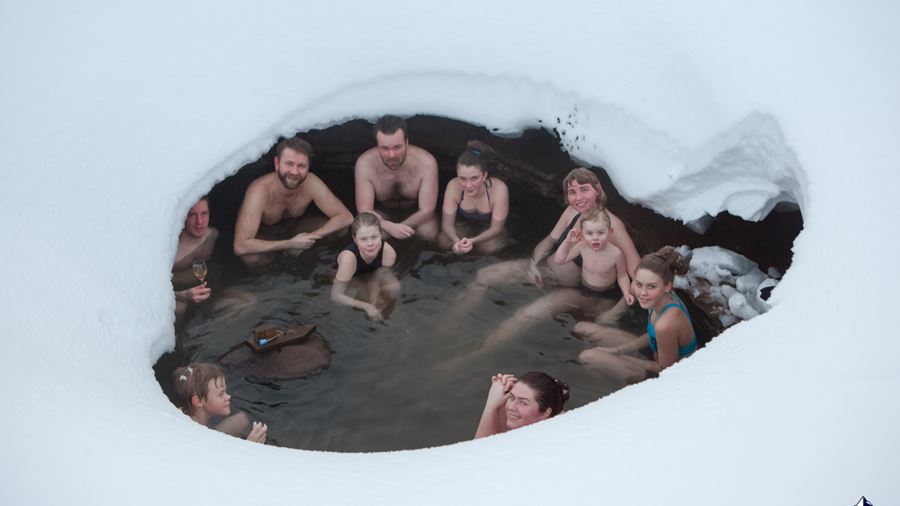 people bathe in hot spring during winter