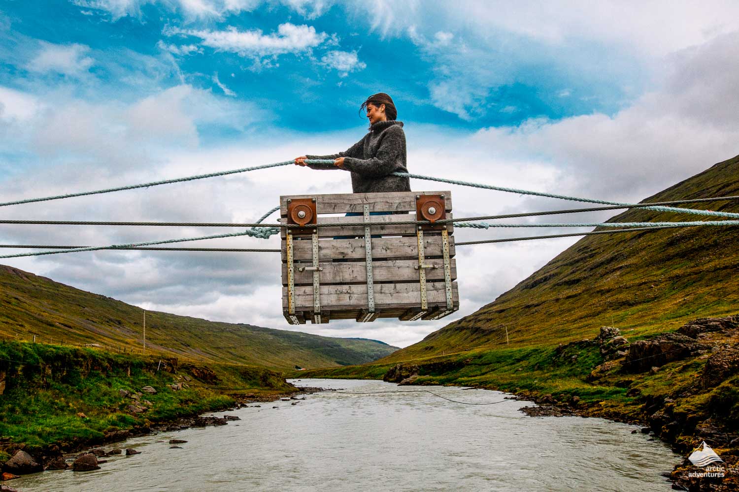 woman crossing river by cable ferry
