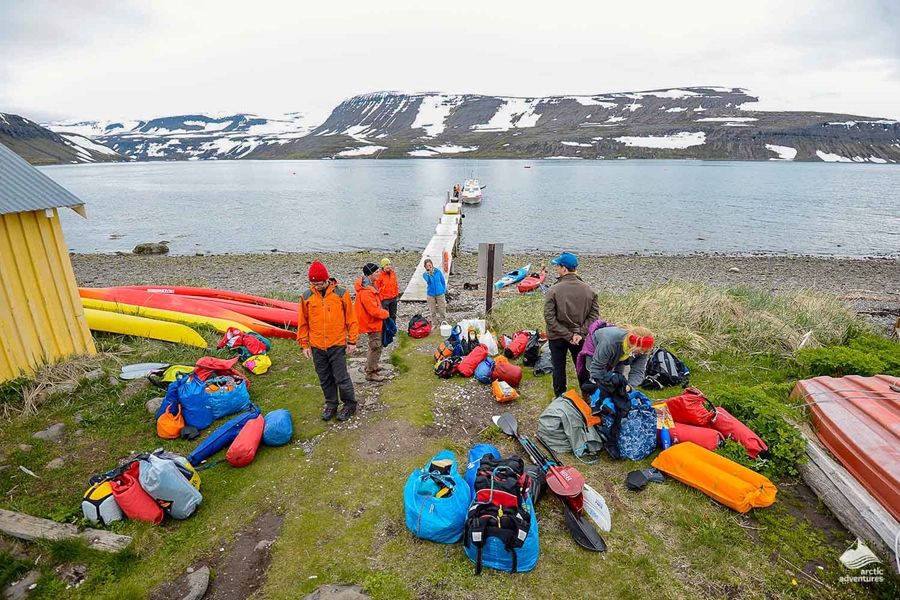 people preparing equipment for kayaking