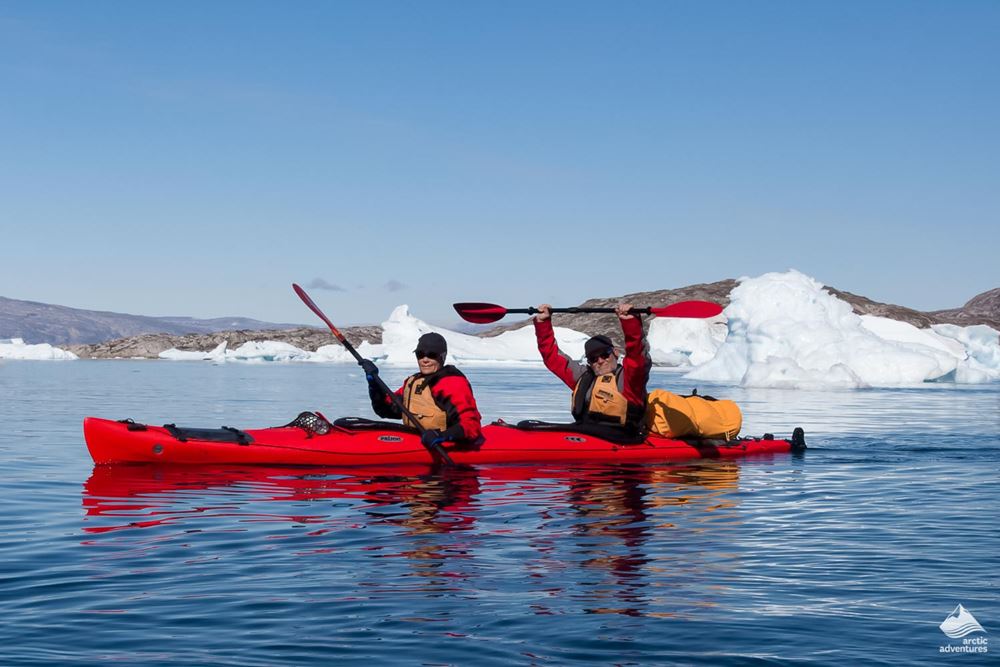 two men kayaking in glacial lagoon