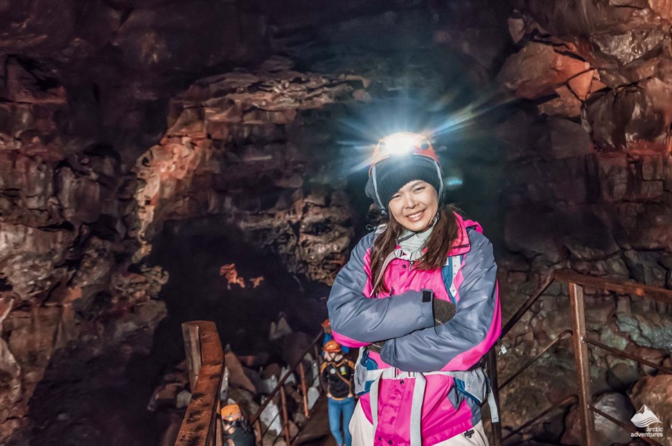 smiling woman in Raufarholshellir Lava cave