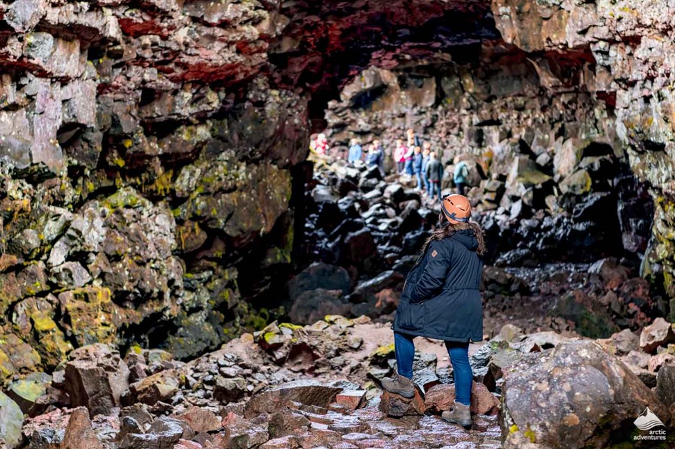 people entering Raufarholshellir Lava Tube in Iceland