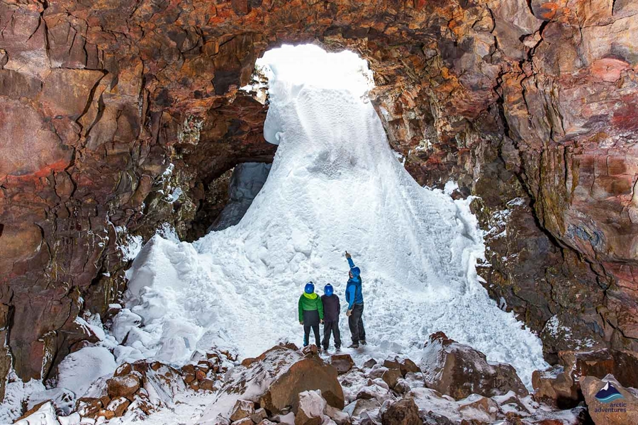people exploring lava tunnel