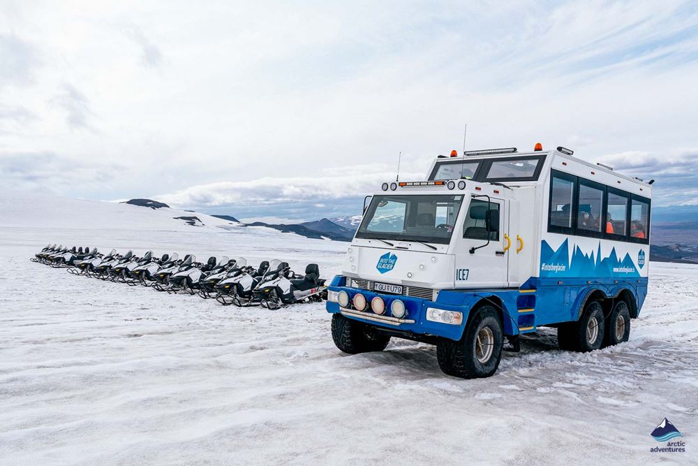 tour truck and snowmobiles