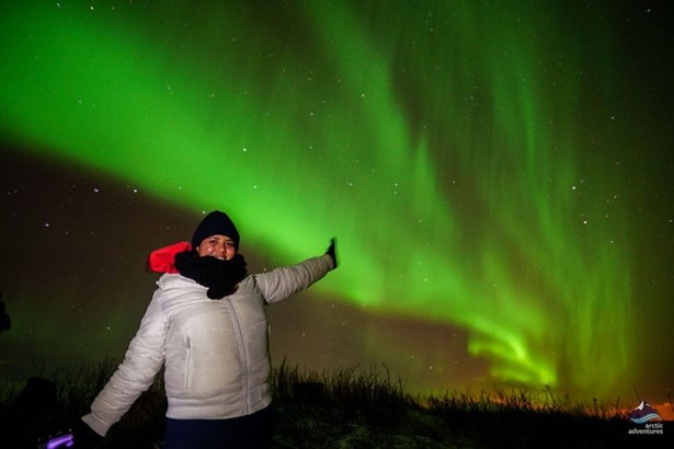 woman excited of seeing Aurora Borealis