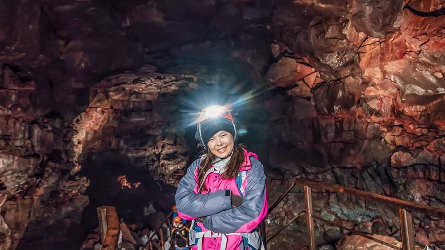 woman standing in lava cave