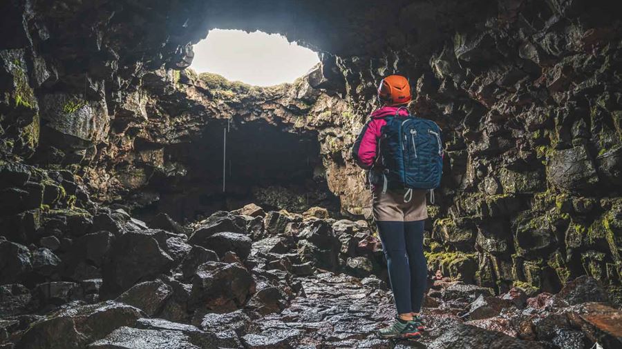 explorer inside lava tunnel