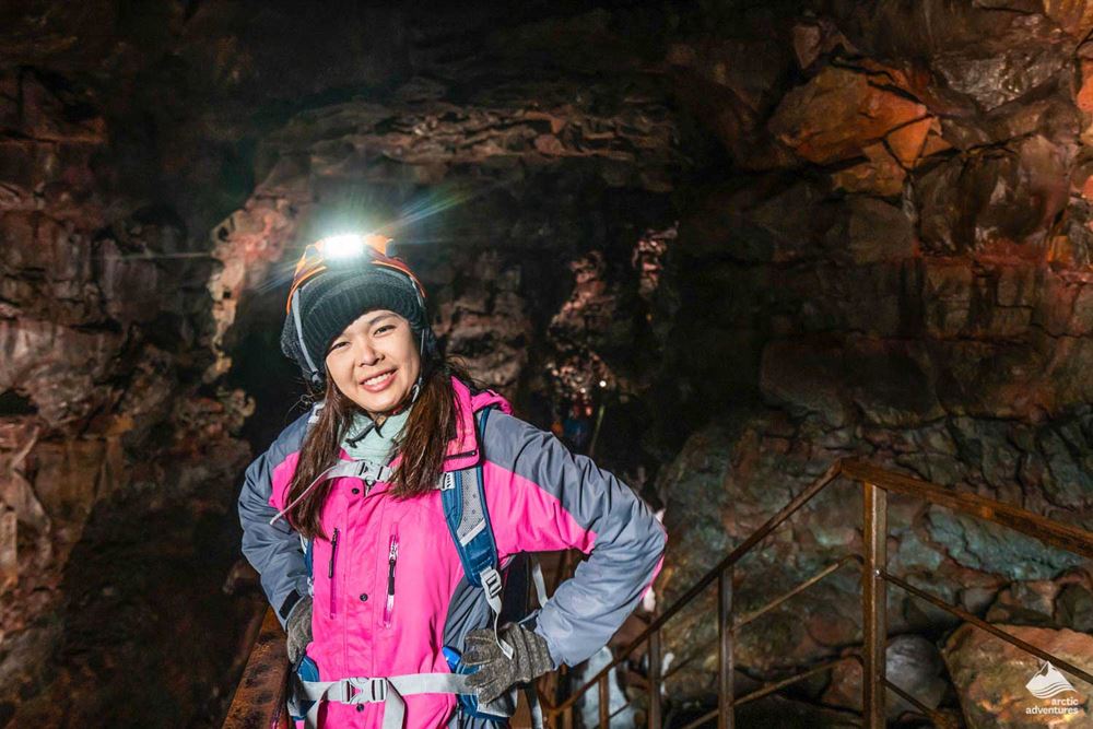 excited woman inside lava tunnel
