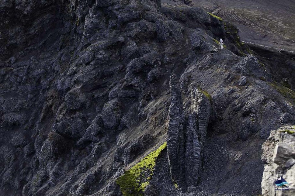 person hiking on Thorsmork volcano in Iceland