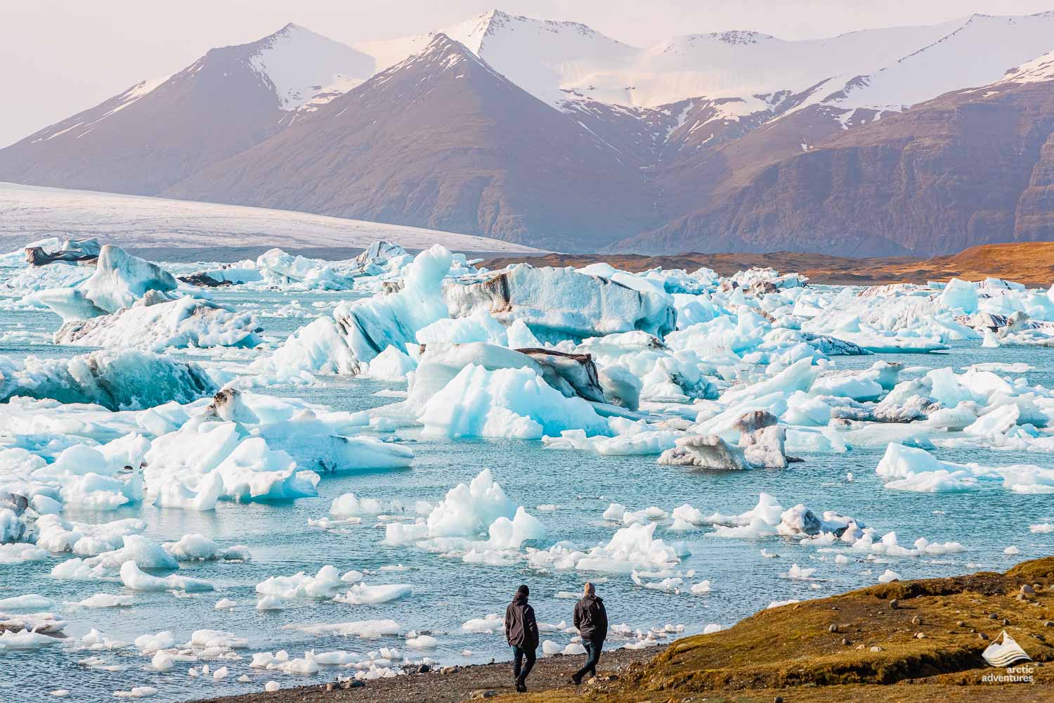 people walking near Jokulsarlon Glacier Lagoon in Iceland