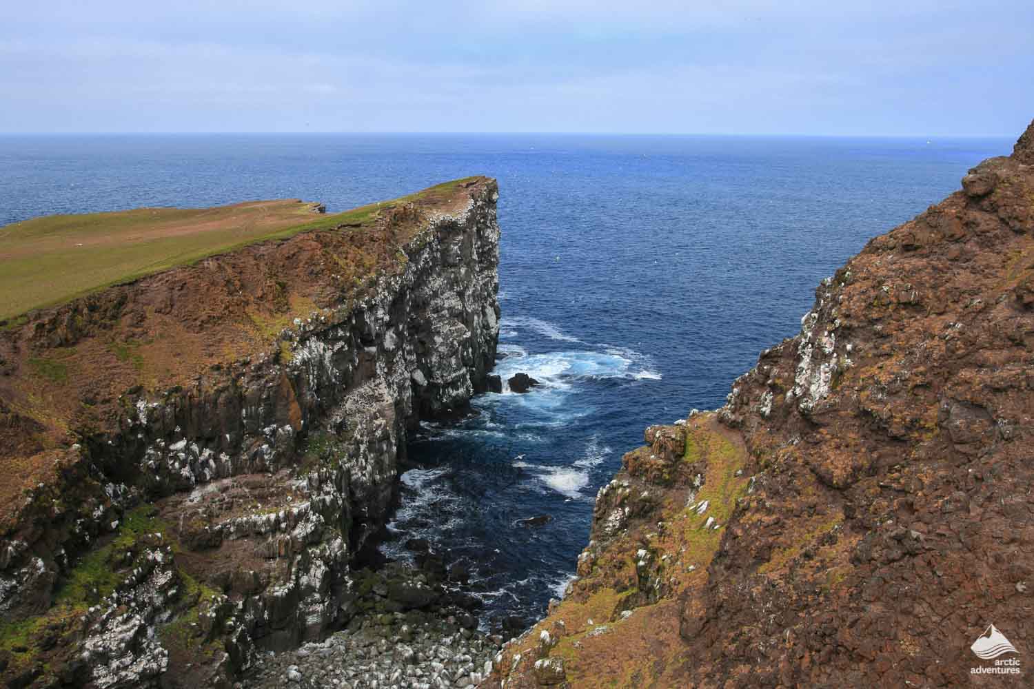 cliffs by sea of Grimsey island in Iceland