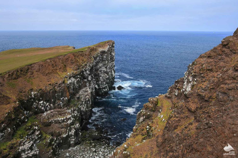 cliffs by sea of Grimsey island in Iceland