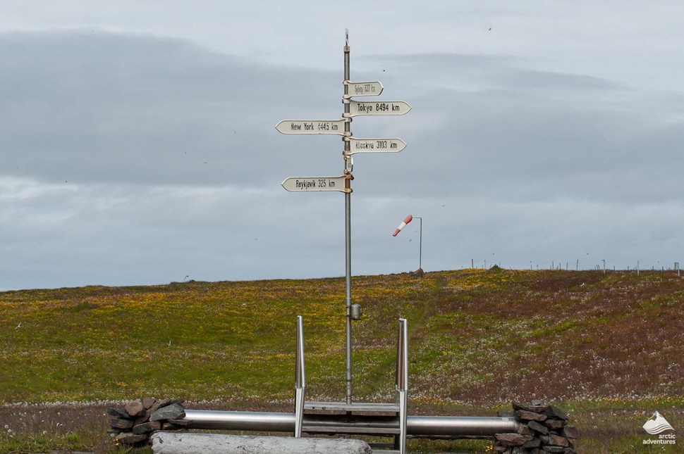 sign showing the distance till capitals from Iceland