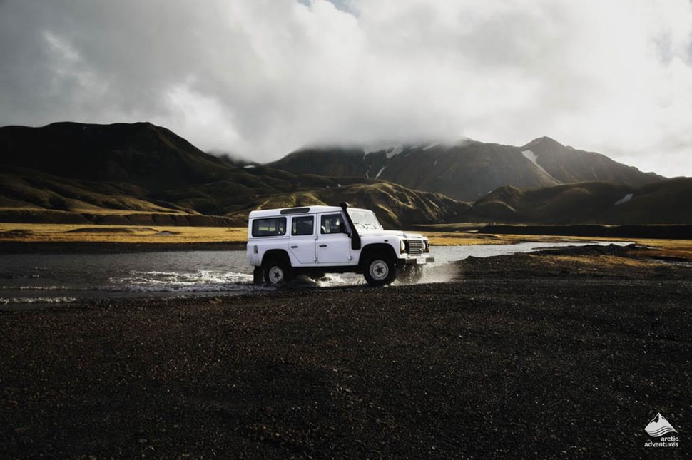 Jeep going through river in Iceland