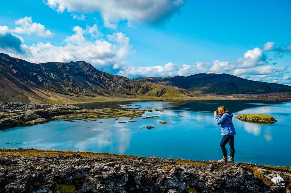 woman taking pictures at Landmannalaugar near lake
